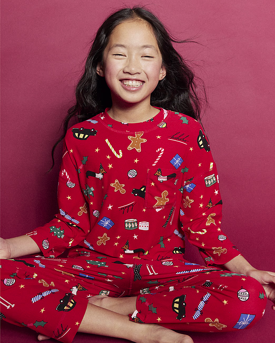 A child model wears River Island's Kids Red Family Christmas Pyjama Set