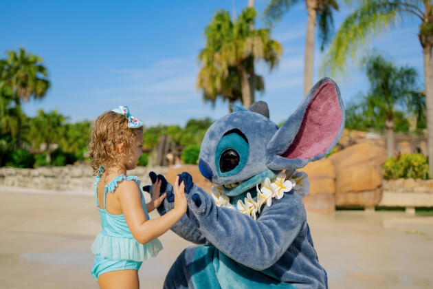 A young girl meets Stitch at a waterpark