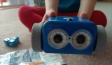 Close up of a child holding Botley the Coding Robot 2.0