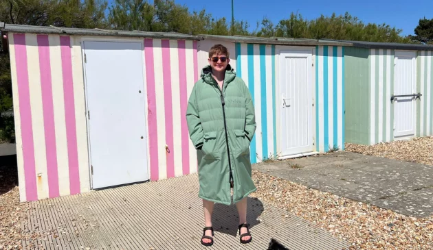 Journalist Poppy O'Neill models the Vivida Puffer Unisex 100% Recycled Parka Changing Robe