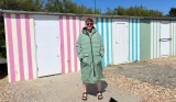 Journalist Poppy O'Neill models the Vivida Puffer Unisex 100% Recycled Parka Changing Robe