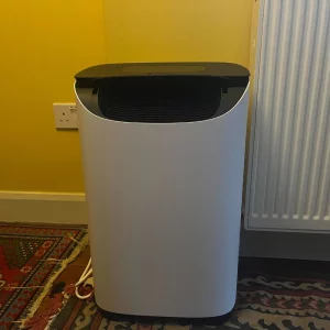 Journalist Poppy O'Neill hand testing the Meaco DD8L Pro Desiccant Dehumidifier