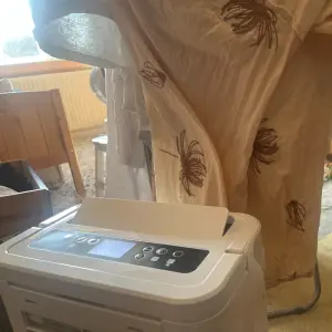 Mumsnet Home editor Poppy O'Neill hand testing the Blyss 16l/d Dehumidifier WDH-316DB