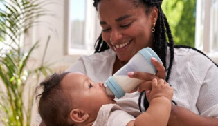 Mother bottle feeding her baby