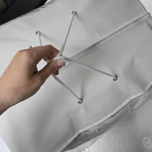 The Soak & Sleep Goose Down Mattress Topper in its bag