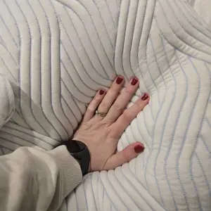 A hand presses the TEMPUR Cloud SmartCool Pillow