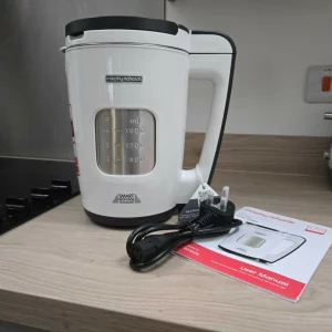 The Morphy Richards Total Control soup maker with cable atop a wooden surface