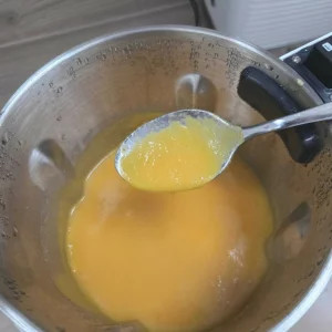 A close up of golden carrot soup in the Morphy Richards Total Control soup maker