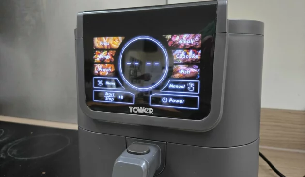 Close-up of the Tower AirX AI 5L air fryer touchscreen showing cooking presets including fries, wings, steak and fish.