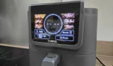 Close-up of the Tower AirX AI 5L air fryer touchscreen showing cooking presets including fries, wings, steak and fish.