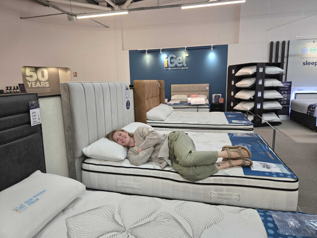 Rebecca Roberts lies down on the Bensons iGel mattress instore