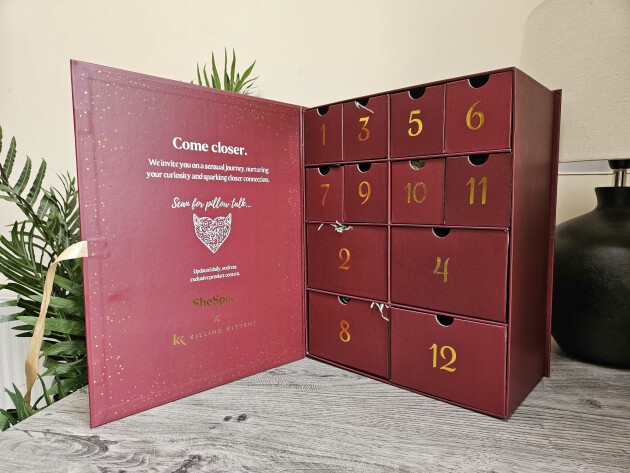 The SheSpot Advent calendar open on a table to reveal the 12 drawers