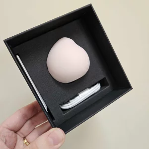 A hand holding the HANX Cindy against a wall