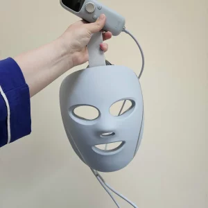 A tester holds the Shark Beauty CryoGlow Under-Eye Cooling and LED Anti-Ageing and Blemish Repair Mask