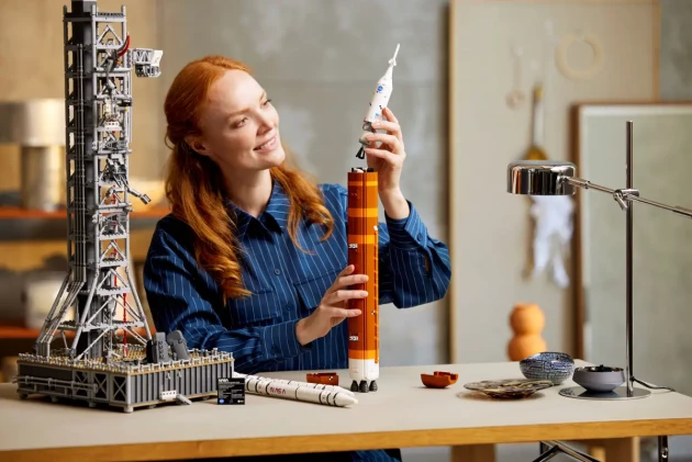 A woman examines LEGO's NASA Artemis Space Launch System
