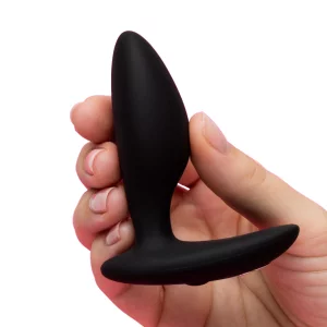 A product image of a hand holding the We-Vibe Ditto+ Rechargeable Remote and App Control Vibrating Butt Plug