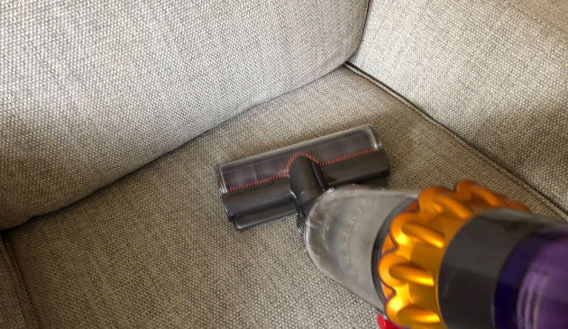 Vacuuming a sofa