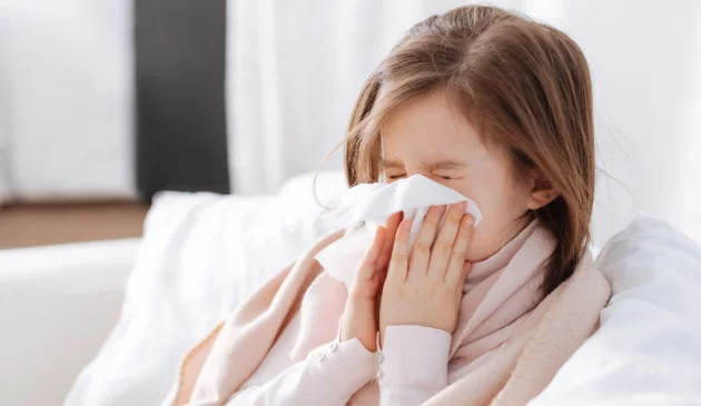 a girl blowing her nose