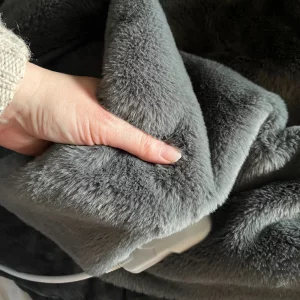 Journalist Poppy O'Neill hand testing the Cosi Home® Luxury Faux Fur Heated Throw