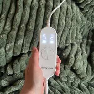 Mumsnet journalist Poppy O'Neill hand testing the Morphy Richards EverCosy Luxury Striped Heated Throw