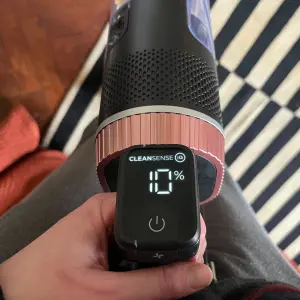 Mumsnet editor Poppy O'Neill testing the Shark Stratos Cordless Stick Vacuum Cleaner IZ400UK