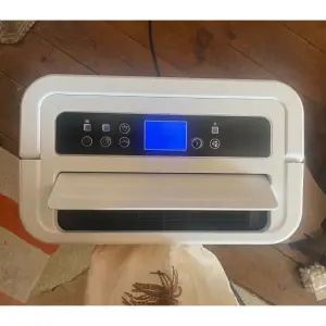 Mumsnet Home editor Poppy O'Neill hand testing the Blyss 16l/d Dehumidifier WDH-316DB