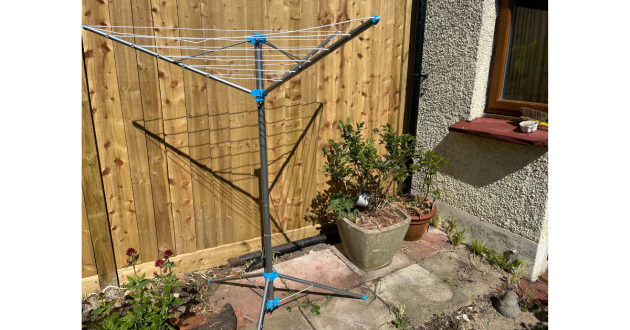 Mumsnet home editor Poppy O'Neill testing the Minky Freestanding Portable Rotary Airer