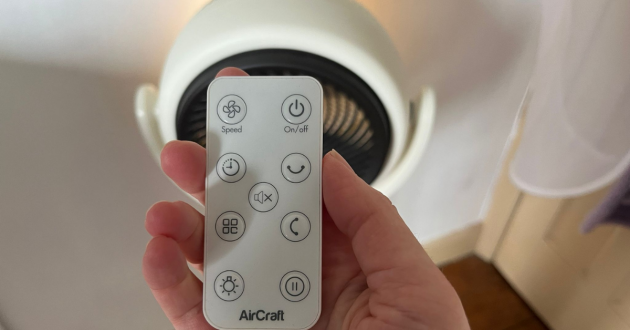 Mumsnet home editor Poppy O'Neill hand testing the AirCraft LUME Quiet Air Circulator Fan