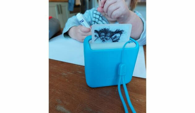a toddler playing with a yoto mini