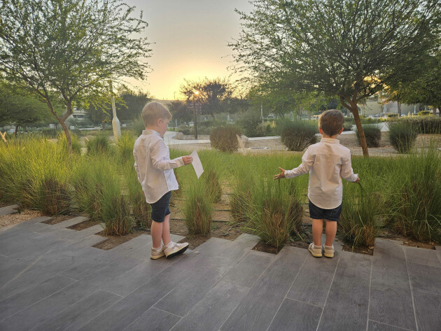 A view of my children from behind looking out across the ERTH Abu Dhabi central plaza at sunset