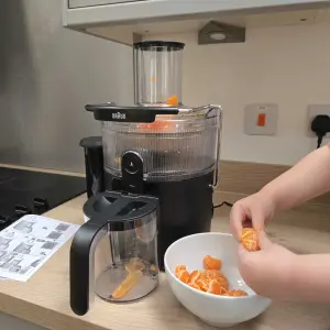 A view of the Braun MultiJuice 5 with a child adding fruit