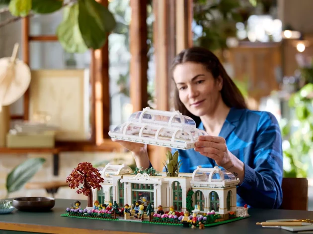 A woman examines LEGO's IDEAS The Botanical Garden
