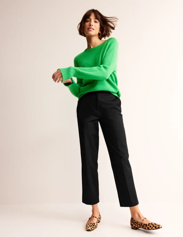 A model wearing Kew bi-stretch trousers by Boden
