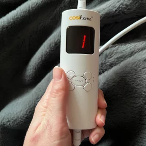 Journalist Poppy O'Neill hand testing the Cosi Home® Luxury Faux Fur Heated Throw