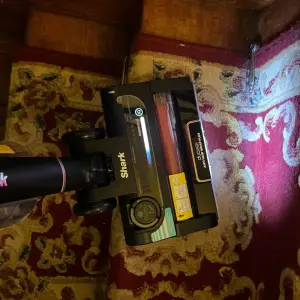 Mumsnet editor Poppy O'Neill testing the Shark Stratos Cordless Stick Vacuum Cleaner IZ400UK