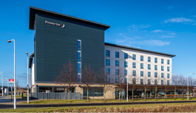 a grey hotel with lots of windows