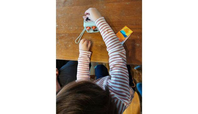 a little girl playing with a yoto mini
