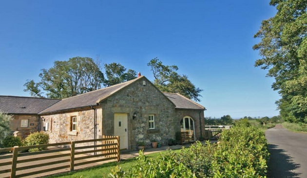 a stone cottage on a sunny day