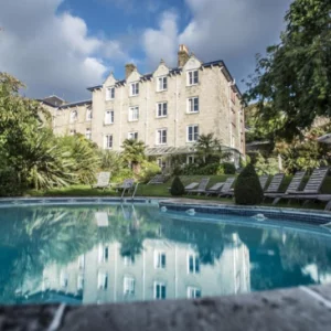 a hotel with a round pool with sunloungers