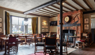 a cosy pub dining room with exposed beams