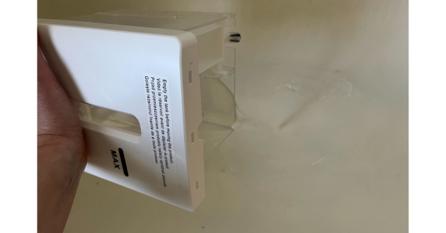 Mumsnet Home editor Poppy O'Neill hand testing the Blyss 16L Dehumidifier WDH-316DB