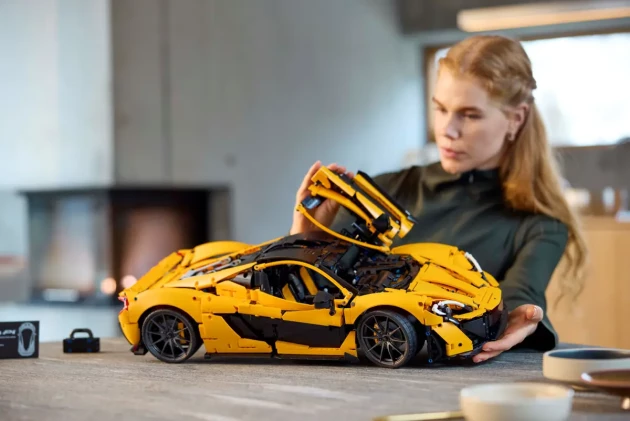 A woman examines LEGO's McLaren P1™