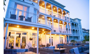 a hotel at duskwith lights on every balcony