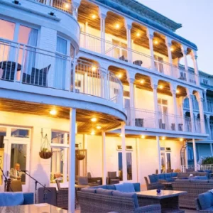 a hotel at duskwith lights on every balcony