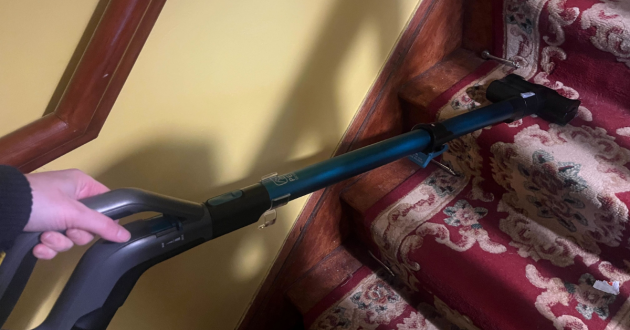 Mumsnet journalist Poppy O'Neill hand testing the Vax LiftOut Reach Pet Design vacuum cleaner