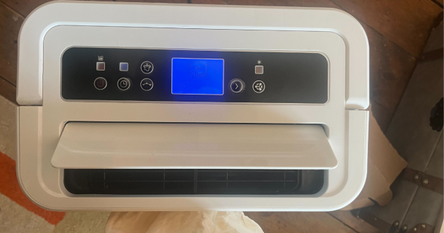 Mumsnet Home editor Poppy O'Neill hand testing the Blyss 16L Dehumidifier WDH-316DB