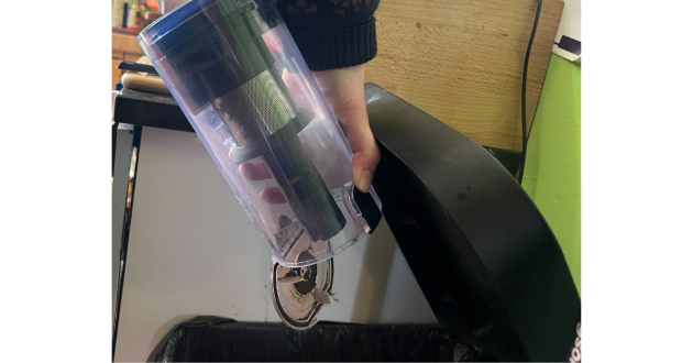 Mumsnet home editor Poppy O'Neill testing the Beldray Airfinity Cordless Vacuum Cleaner