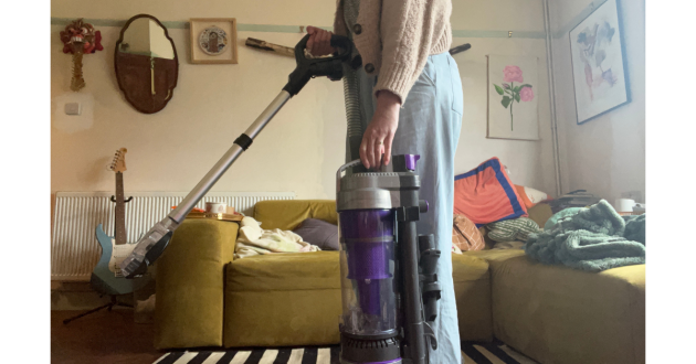 Mumsnet home editor Poppy O'Neill testing the VAX Air Stretch Pet Max Corded Upright Vacuum Cleaner