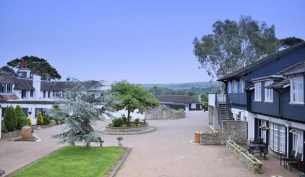the courtyard of a hotel, with grass and trees