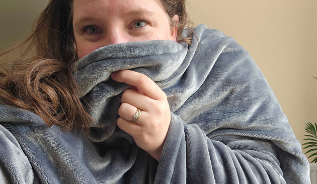 MNHQ editor Beccy Roberts wearing The Snuggler Heated Throw